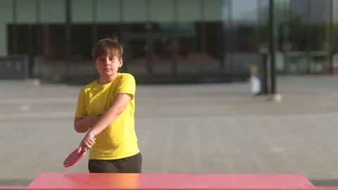 Boy Hitting Table Tennis Ball Outdoors Stock Footage 336274582