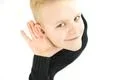 The boy hold his hand near ear. View from above Photo