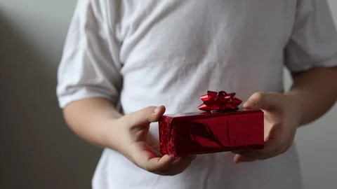 The boy hold a red gift, Valentines day. Christmas gift. Stock Footage 147453025