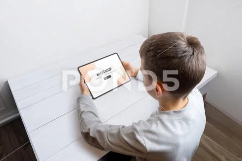 Boy hold tablet mockup for game or app PSD Template