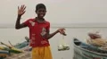 Boy holding a bag with fish and waving in Sri Lanka HD Footage