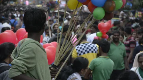 Boy holding ballons in crowd Stock Footage 47460646