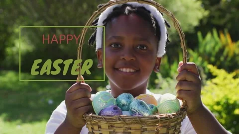 Boy holding basket, raising eggs to lens after HAPPY EASTER graphic appearing Video stock 331026127