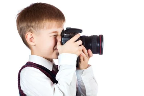 Boy is holding camera and taking a photo Stock Photos