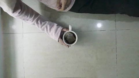 A boy holding a cup of coffee Stock Footage 131709826