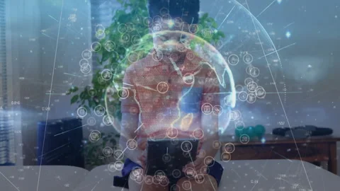 Boy holding device, revealing rotating 3D globe, tapping icons and exploring Stock Footage 310972825