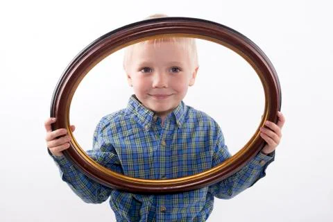 Boy holding frame Stock Photos