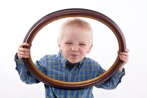 Boy holding frame Stock Photos