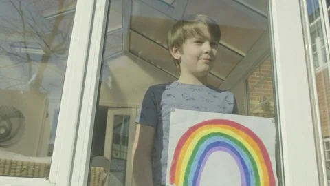 Boy holding an image of a rainbow Video stock 127182151