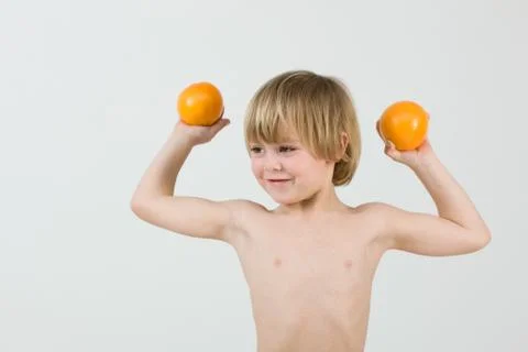 Boy holding oranges 写真素材
