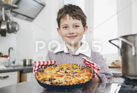 Boy holding a pizza, smiling, portrait Stock Photos