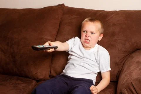 Boy holding a remote Stock Photos