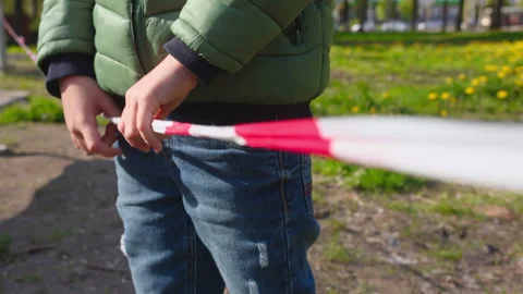 A boy holding on to the safety tape 動画素材 131386853