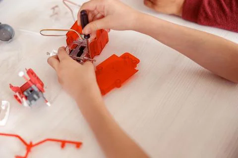 Boy holding a screwdriver and constructor in his hands Stock Photos