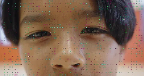Boy holding still for face scan with colored dots flickering, capturing Vídeo Stock 314868264