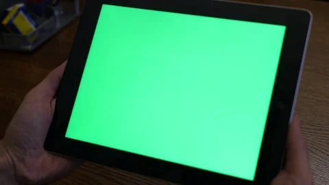 Boy holding a tablet pc with green screen Stock Footage 101546930