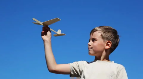 Boy holding toy airplane model Stock Footage 1058704