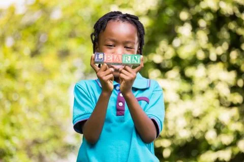 Boy holding the word learn Fotos Stock