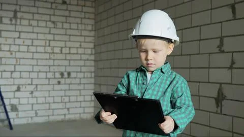 Boy holds a black folder with documents in his hands and studies the room plans Stock Photos
