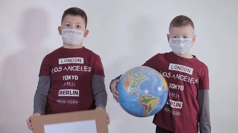 Boy holds a globe, a model of the planet Earth. Child is holding a sign with the Stock Footage 127254236