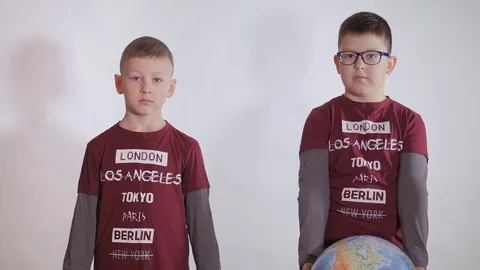 Boy holds a globe, a model of the planet Earth. Child is holding a sign with the Stock Footage 127254395