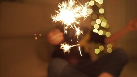 The boy holds a Sparkler and laughs. Sparklers. the sparklers in his hands. New Video stock 100269666