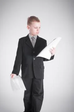 Boy holds two packages of papers Stock Photos