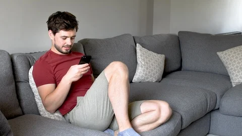 Boy at home using his mobile phone to look at social media Stock Footage 92279016