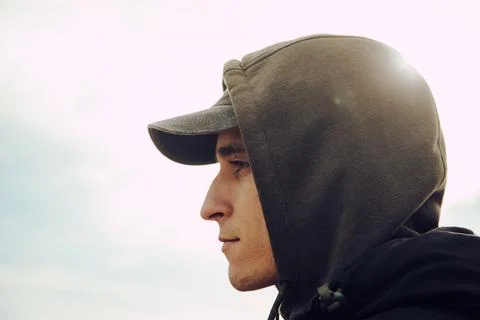 Boy with hood and cap from the side. Portrait Stock Photos