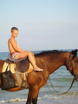 Boy on horseback Stock Photos