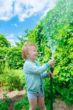 Boy with hose Stock Photos
