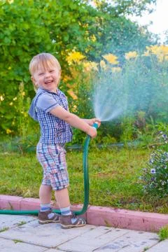 Boy with hose Fotos Stock