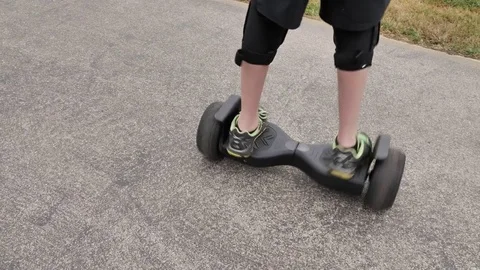 A Boy on a Hoverboard Spins and Accelerates Stock Footage 82167949