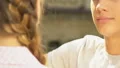 Boy hugging girl and looking at camera, betrayal in relationship, face closeup HD Footage