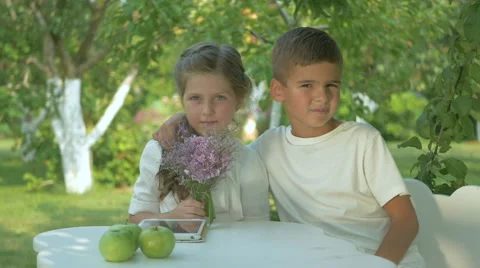 Boy hugging girl in the garden Stock Footage