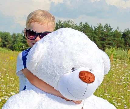 Boy hugging Teddy bear Stock Photos