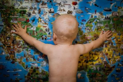 Boy hugs a map of the world Stock Photos