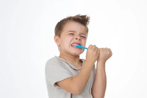 Boy is hurting while cleaning teeth Stock Photos