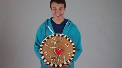 A boy with “I Love U” decorated cookie Stock Footage 22732300