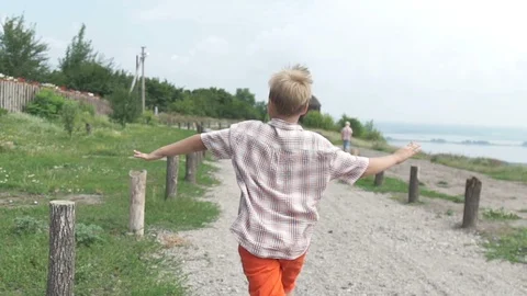 The boy imagines that he is a plane. Children's games and dreams Stock Footage 104701562