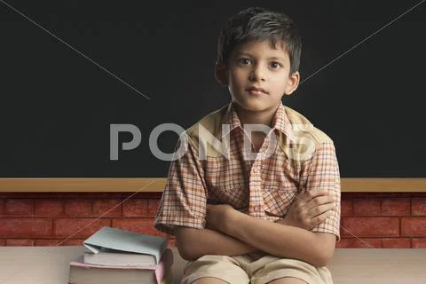 Boy imitating a teacher in a classroom Stock Photos
