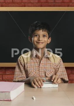 Boy imitating a teacher in a classroom Stock Photos