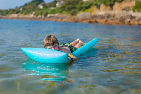 Boy  on inflatable mattress Stock Photos