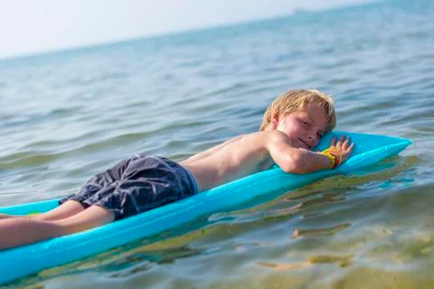 Boy  on inflatable mattress Stock Photos