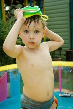 The boy in the inflatable pool Stock Photos