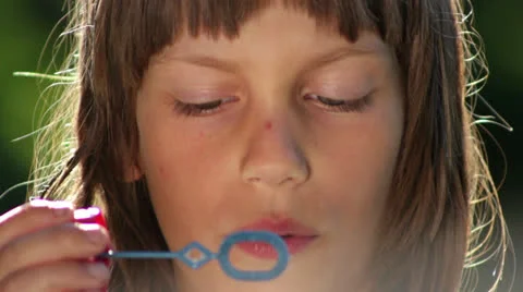 Boy inflates the bubble blower (portrait) Stock Footage 24958014