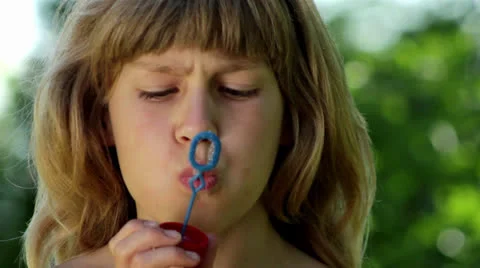 Boy inflates the bubble blower (portrait) Stock Footage 24963219