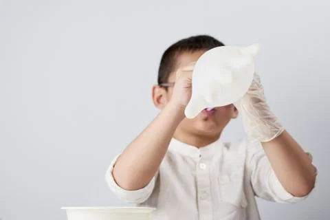 A boy inflating gloves Stock Photos