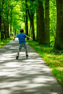 Boy on inline skates, seen from behind Stock Photos