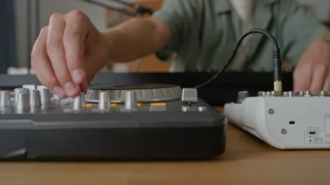 Boy Inserting Cable Plug into Audio Interface, Setting Knobs on DJ Controller 스톡 동영상 314660454